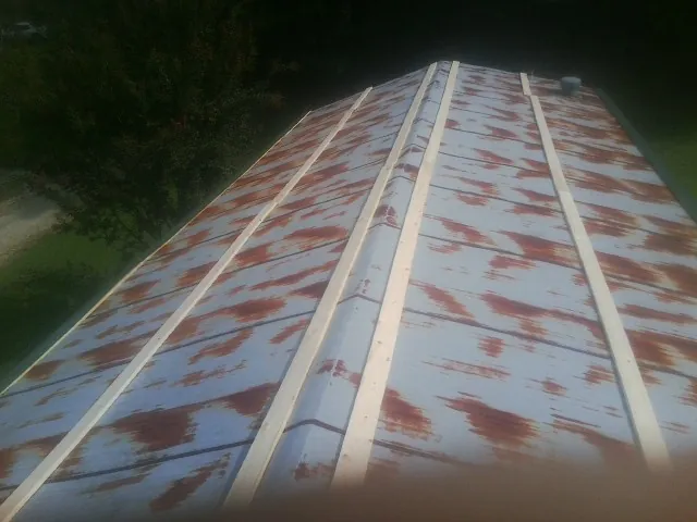 Rusted metal roof panels with new wood purlins before replacement — Storm Damage Roof Repair in Mount Aetna by Roofing Brothers